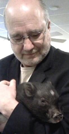 Robert at a customer service seminar for a government client, and his most unusual guest. Yes. A Pig